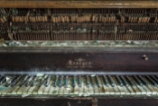 Several keys on this common room piano still functioned, though they had long gone out of tune.