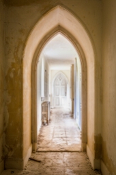 Nested arches visible through a second floor hallway.