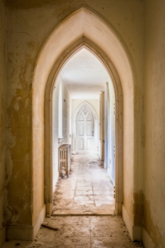 Nested arches visible through a second floor hallway.
