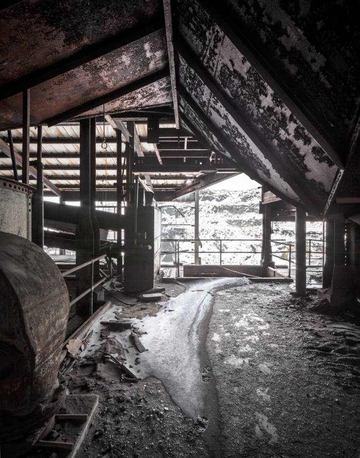 Coal dust mingles with snow drifts where the structure is open to the elements.